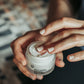 Hands using Truly O2 micro-oxygen hydrating night cream.